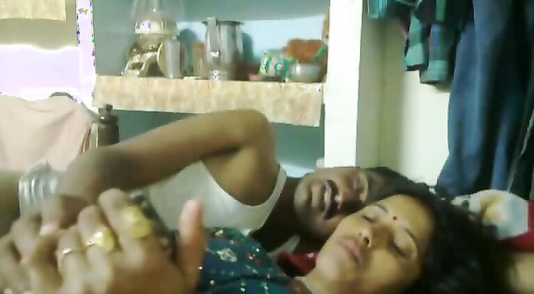 Mumbai raand after sex with her pimp laying watching a porn movie on his mobile who is playing with her boobs.
