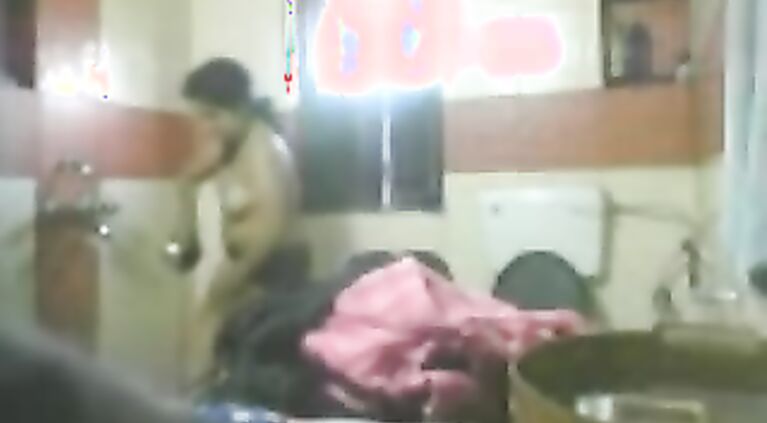 Mature desi bhabhi in bathroom stripping naked unaware of hidden cam being fixed by her dewar to record her naked.