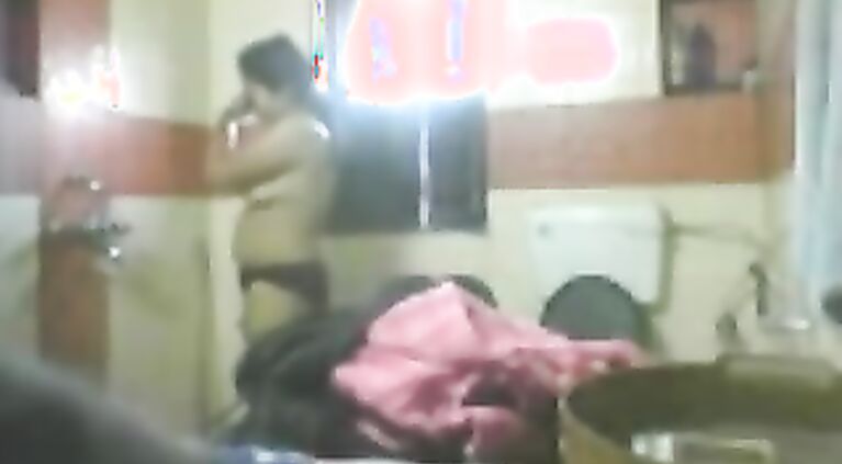 Mature desi bhabhi in bathroom stripping naked unaware of hidden cam being fixed by her dewar to record her naked.