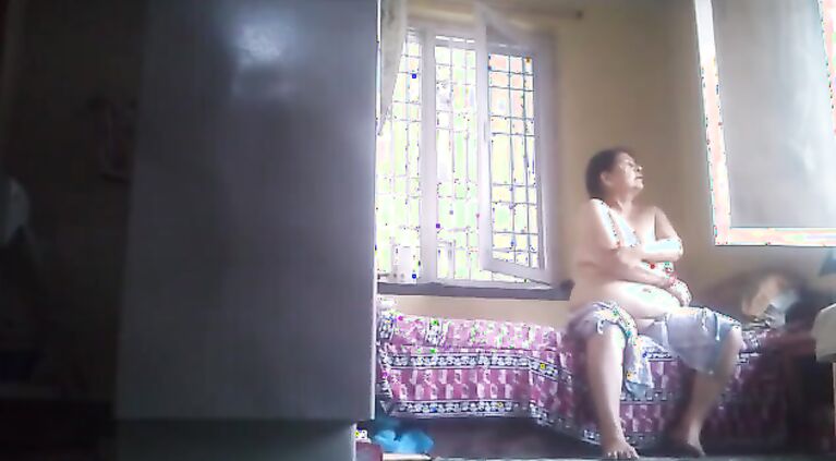 Tamil grannie rubs lotion after bath