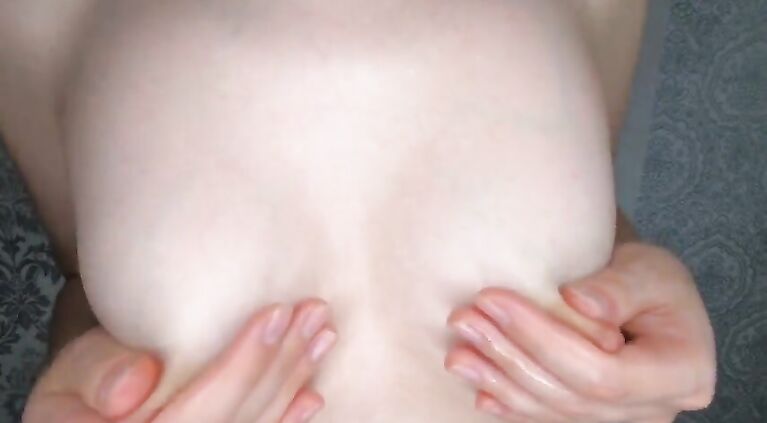 huge titted brunette rubs nipples with oil and plays with them